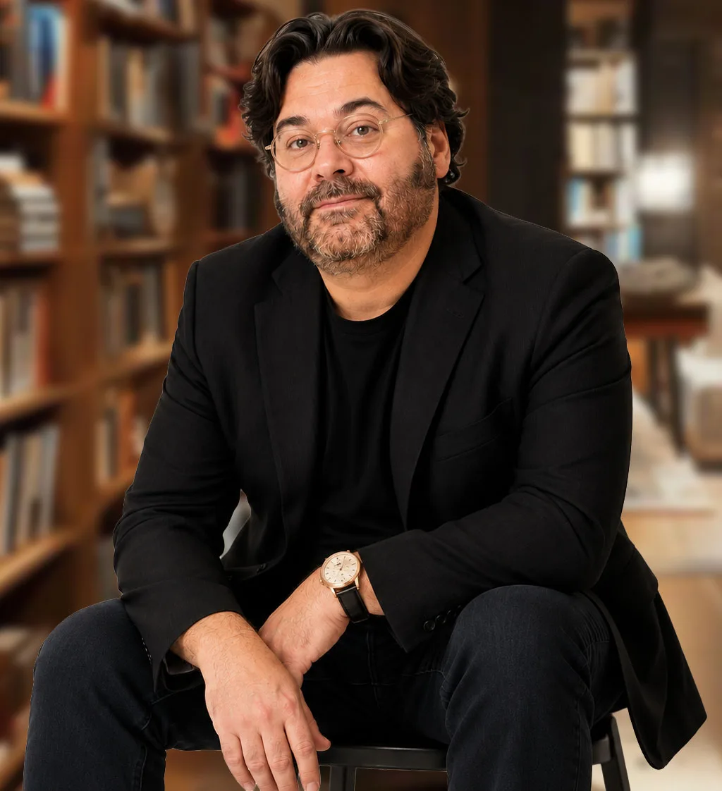 John Andrew Beane seated in a library